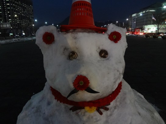 Flowers for its nose and ears, cookies for its eyes, and a glove for its neck